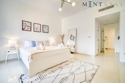 a white bedroom with a bed and a rug at Bahar, Jumeirah Beach Residence JBR - Mint Stay in Dubai