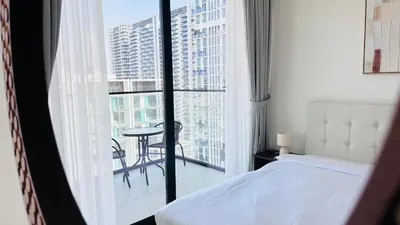 a bedroom with a bed and a balcony with a table at Standard 1bedroom Apartment Binghatti Emerald JVC in Dubai