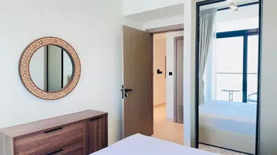 a bedroom with a mirror and a bed at Standard 1bedroom Apartment Binghatti Emerald JVC in Dubai
