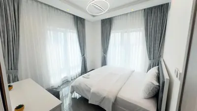a bedroom with a white bed and a window at Dubai Marina- Cozy 2BHK Apartment in Dubai