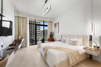 a bedroom with a large bed and a large window at Studio Azizi Riviera 24 Community View in Dubai