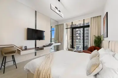 a hotel room with a bed and a tv at Studio Azizi Riviera 24 Community View in Dubai