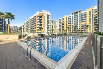 a swimming pool with buildings in the background at Studio Azizi Riviera 24 Community View in Dubai