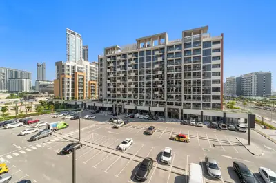 a parking lot in front of a large building at Studio Azizi Riviera 24 Community View in Dubai
