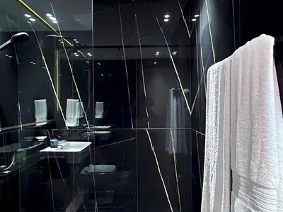a bathroom with a glass shower with a sink at City Views & Comforts at Binghatti Corner in Dubai