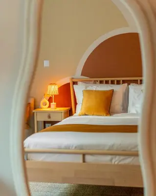 a bedroom with a bed with an orange headboard at Boho Nordic Bliss in Dubai in Dubai