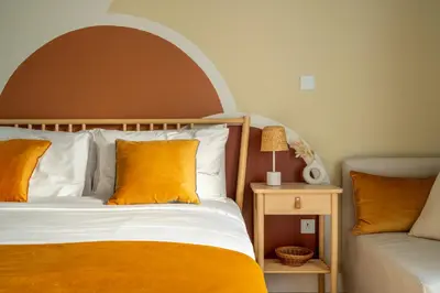 a bedroom with an orange and white bed and a chair at Boho Nordic Bliss in Dubai in Dubai