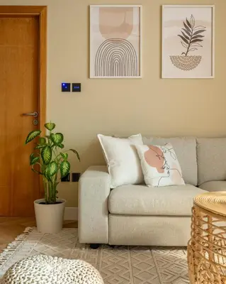 a living room with a couch and a plant at Boho Nordic Bliss in Dubai in Dubai