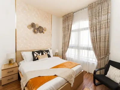 a bedroom with a bed and a window at Serene 1BR in Diamond Views 3 JVC - Pool Access & Peaceful Living , Managed by Think Realty in Dubai