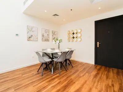 a dining room with a table and chairs at Serene 1BR in Diamond Views 3 JVC - Pool Access & Peaceful Living , Managed by Think Realty in Dubai