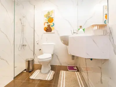 a bathroom with a toilet and a sink at Serene 1BR in Diamond Views 3 JVC - Pool Access & Peaceful Living , Managed by Think Realty in Dubai