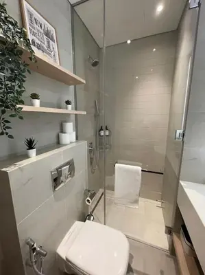 a bathroom with a shower and a toilet and a sink at Luxury Studio apartment in JVC, Oakley Square Residences in Dubai