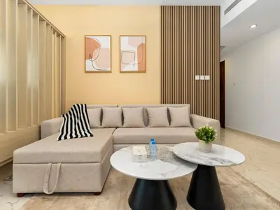 a living room with a couch and two tables at Spacious Home Near Metro & Beach in Dubai Marina in Dubai