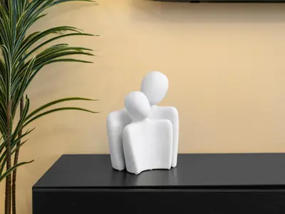 two white sculptures sitting on a table next to a plant at Spacious Home Near Metro & Beach in Dubai Marina in Dubai