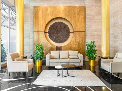 a lobby with couches and a table at Spacious Home Near Metro & Beach in Dubai Marina in Dubai