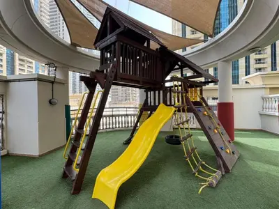 a play room with a slide and a playground at Marina Crown 1 BR Modern Apartment Full Sea View in Dubai
