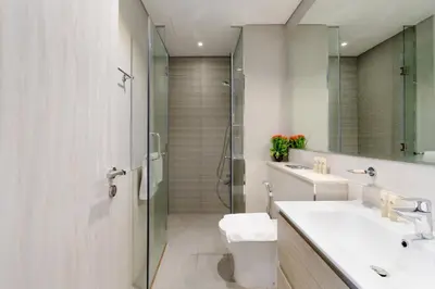 a bathroom with a toilet and a sink and a shower at Stylish and Versatile for Business or Leisure in Dubai