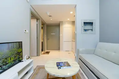 a living room with a couch and a table at Stylish and Versatile for Business or Leisure in Dubai
