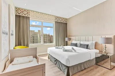 a bedroom with a large bed and a large window at Sophisticated 3 Bed Palm Jumeirah w Beach Access in Dubai