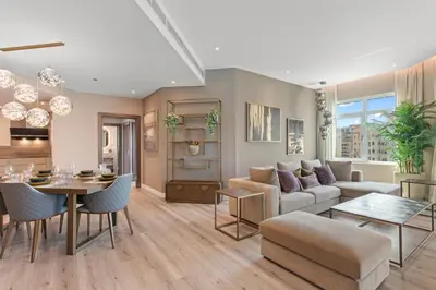 a living room with a couch and a table at Sophisticated 3 Bed Palm Jumeirah w Beach Access in Dubai