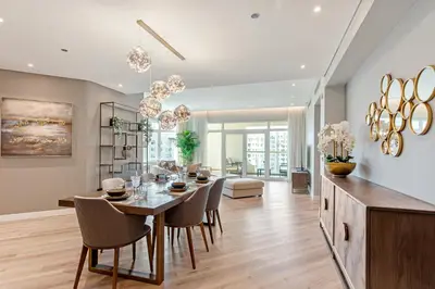 a dining room and living room with a table and chairs at Sophisticated 3 Bed Palm Jumeirah w Beach Access in Dubai