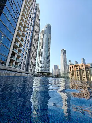 a pool of water in a city with tall buildings at Luxurious apartment in Downtown, Dubai in Dubai