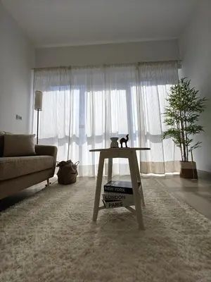 a cat sitting on a table in a living room at Luxurious apartment in Downtown, Dubai in Dubai