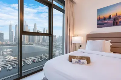 a bedroom with a bed and a large window at Modern Home with Incredible View & Private Beach in Dubai