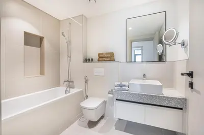 a white bathroom with a sink and a toilet at Modern Home with Incredible View & Private Beach in Dubai
