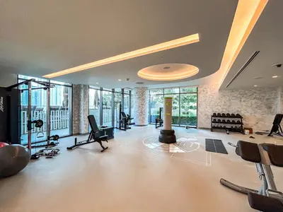 a room with a gym with a lot of exercise equipment at Modern Home with Incredible View & Private Beach in Dubai