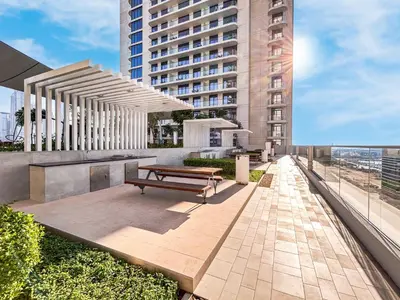 a bench on a patio with a building at Modern Home with Incredible View & Private Beach in Dubai