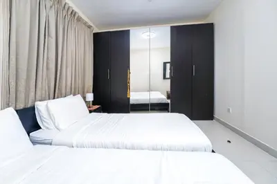 a bedroom with two beds and a mirror at 2-Bedroom Marina Skyline View in JLT in Dubai