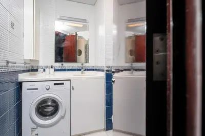 a bathroom with a washing machine and a sink at 2-Bedroom Marina Skyline View in JLT in Dubai