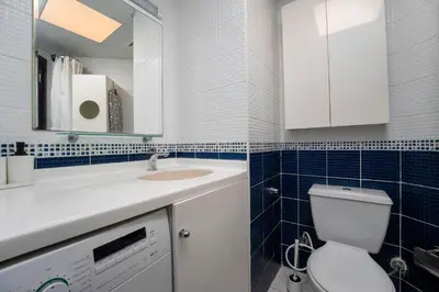 a bathroom with a toilet and a sink and a mirror at 2-Bedroom Marina Skyline View in JLT in Dubai
