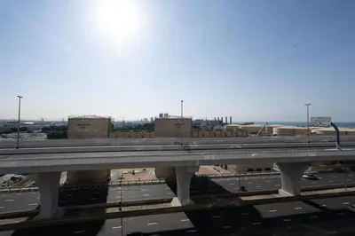 a bridge over a highway in a city at Chic 2BR Apartment in Dubai Marina, near Marina Beach and The Walk in Dubai
