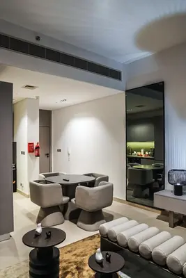 a living room with a table and chairs at Stylish & Cozy Apartment Awaits You in Dubai