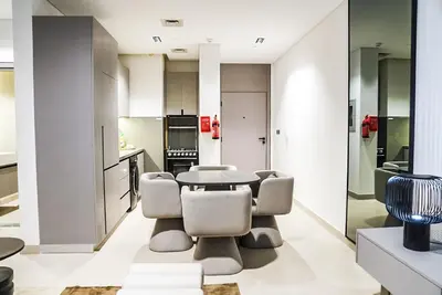 a kitchen and dining room with a table and chairs at Stylish & Cozy Apartment Awaits You in Dubai