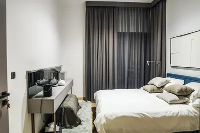 a bedroom with a large bed and a television at Stylish & Cozy Apartment Awaits You in Dubai