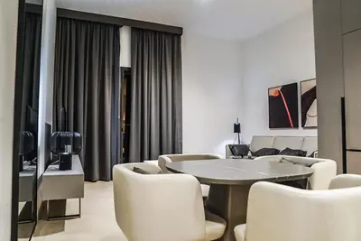 a living room with a table and chairs at Stylish & Cozy Apartment Awaits You in Dubai