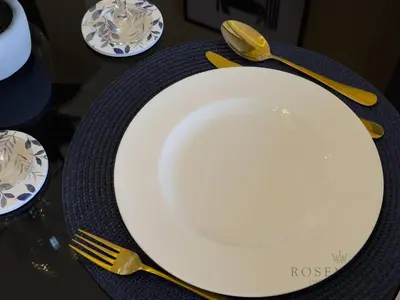 a white plate sitting on a table with a fork and knife at Spacious & Cozy 1BR - Stunning City View in Dubai