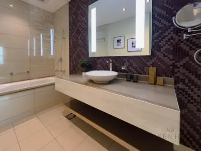 a bathroom with a sink and a mirror at Spacious & Cozy 1BR - Stunning City View in Dubai