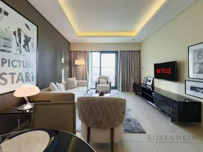 a hotel room with a bed and a tv at Spacious & Cozy 1BR - Stunning City View in Dubai