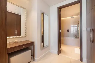 a bathroom with a sink and a mirror and a tub at Luxury Living - Spectacular Burj Khalifa Views in Dubai