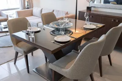 a dining room table and chairs with wine glasses on it at Luxury Living - Spectacular Burj Khalifa Views in Dubai