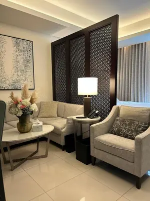 a living room with a couch and chairs and a table at The Address Downtown Studio 1911 in Dubai