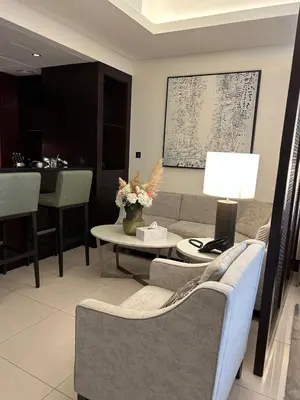 a living room with a couch and a table at The Address Downtown Studio 1911 in Dubai