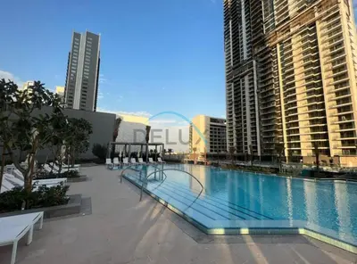 a large swimming pool in a city with tall buildings at Appealing 3BR at 17 Icon Bay Dubai Creek Harbour by Deluxe Holiday Homes in Dubai