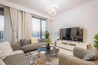 a living room with couches and a large tv at Appealing 3BR at 17 Icon Bay Dubai Creek Harbour by Deluxe Holiday Homes in Dubai