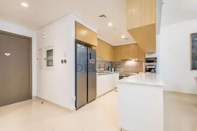 a large kitchen with a stainless steel refrigerator at Appealing 3BR at 17 Icon Bay Dubai Creek Harbour by Deluxe Holiday Homes in Dubai