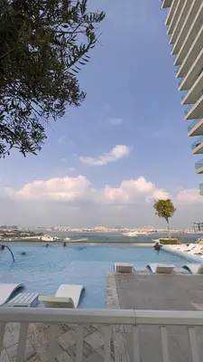 a swimming pool with a view of the water at Emaar Beachfront Luxe Retreat in Dubai